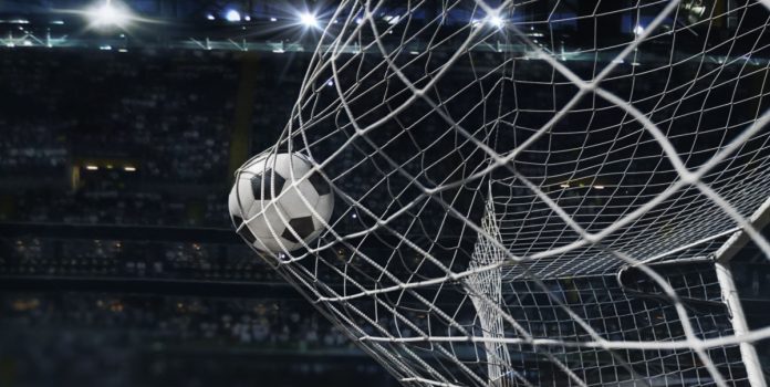 Bola de futebol entrando na goleira