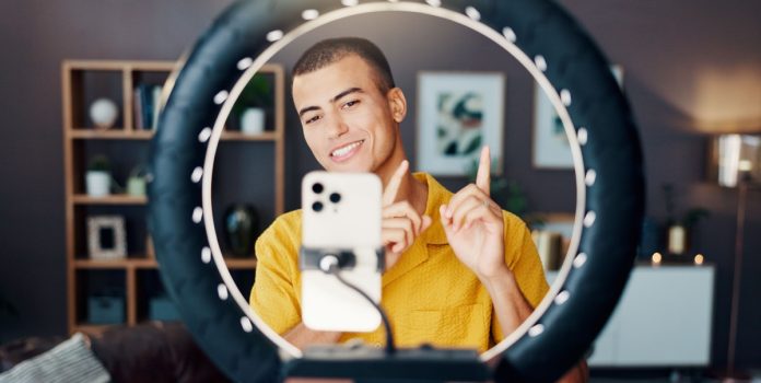 betsul-apresenta-novo-influenciador- Homem criando conteúdo com ring light e celular