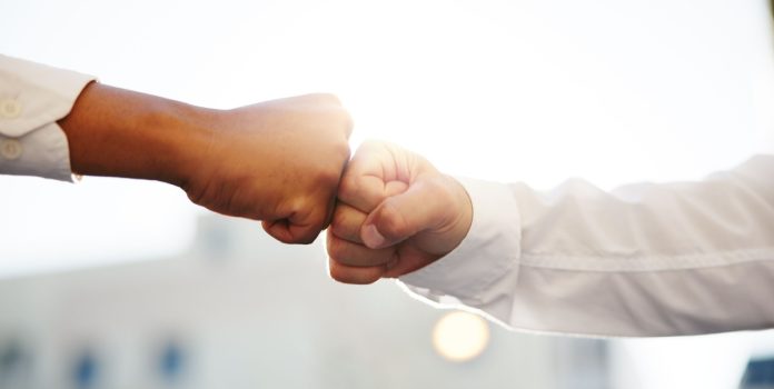Duas mãos dando soquinho em forma de parceria