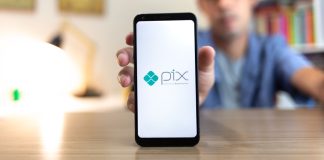Homem segurando celular com o logo do Pix na tela