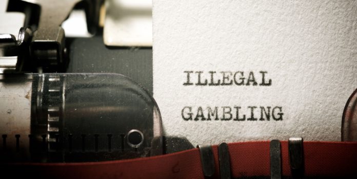 estudo-relação-apostas-ilegais-e-alta-carga-tributária-pwc Folha de papel datilografado com a frase “illegal gambling”