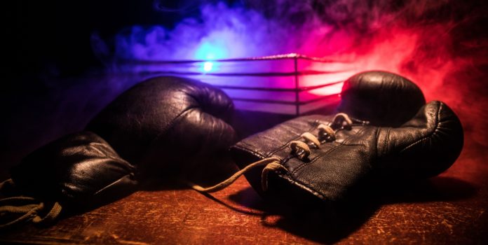 nego-do-borel-e-mendigata-são-embaixadores-da-betsul Luvas de boxe e um ringue de luta vazio atrás