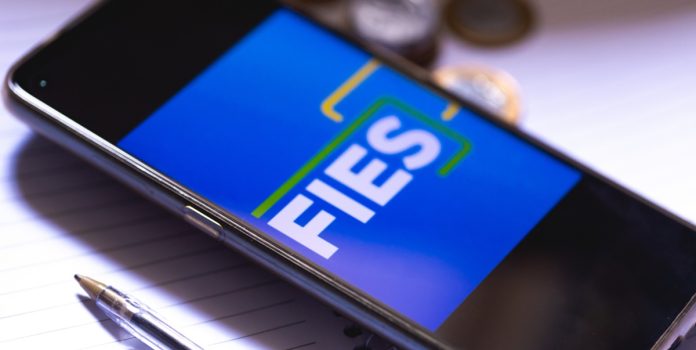 Governo-estende-restricao-temporaria-de-apostas-a-beneficiarios-do-Desenrola-Fies Um celular sobre a mesa com o logo do FIES na tela