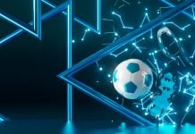 Uma bola de futebol e um par de chuteiras sobre um fundo azul