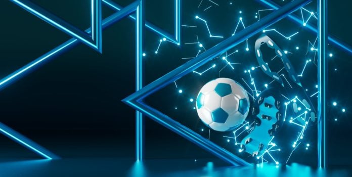 Uma bola de futebol e um par de chuteiras sobre um fundo azul