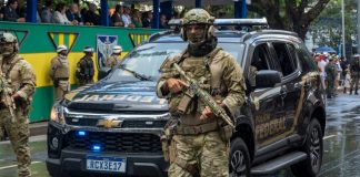 Câmara dos Deputados aprova MP que destina parte da arrecadação das apostas à Polícia Federal Policial Federal armado na rua em frente ao carro da Polícia Federal