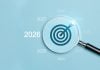 Lupa destacando o ano de 2026 como alvo em fundo azul